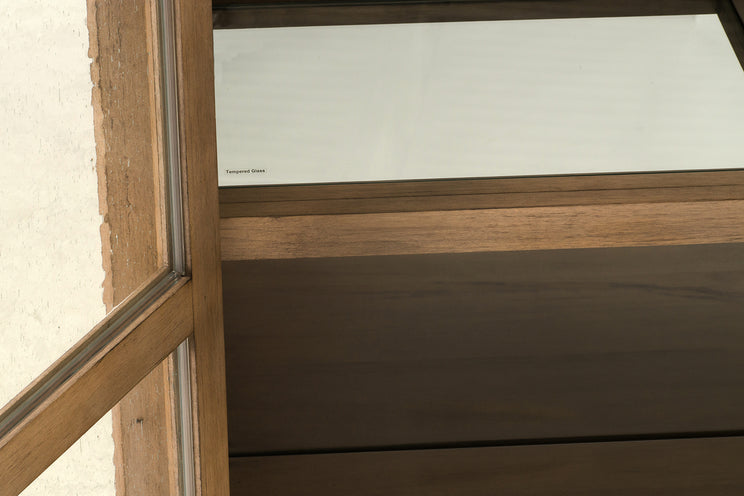 Wooden window frame with glass panel on a neutral background